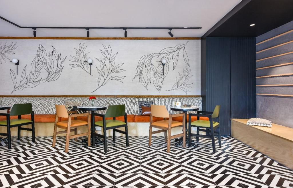 Venus Community Café — Geometric floor tiles with botanical wall art