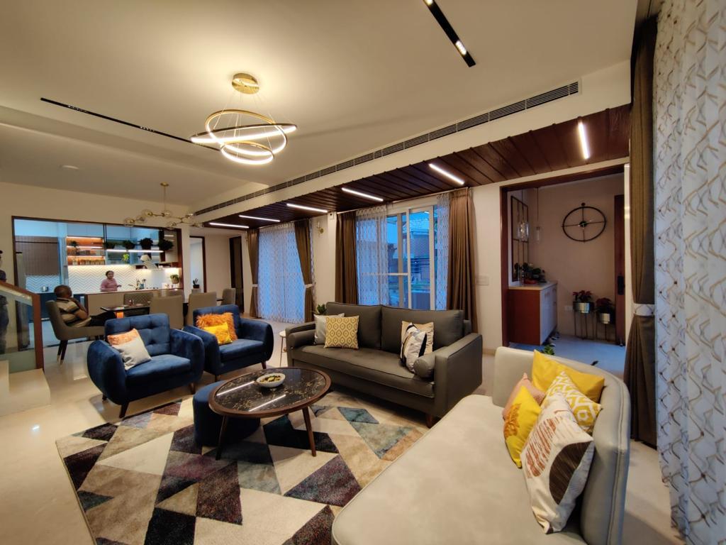 Open-plan living space with contemporary furniture and warm lighting