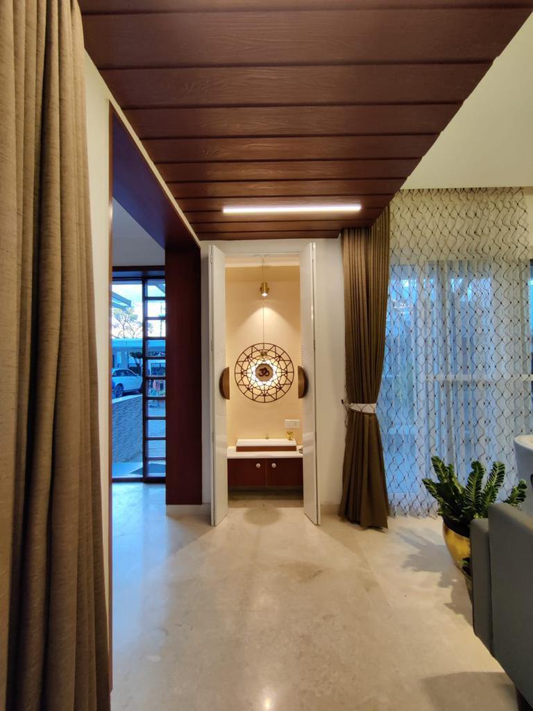 Custom pooja room with Om motif and wooden ceiling