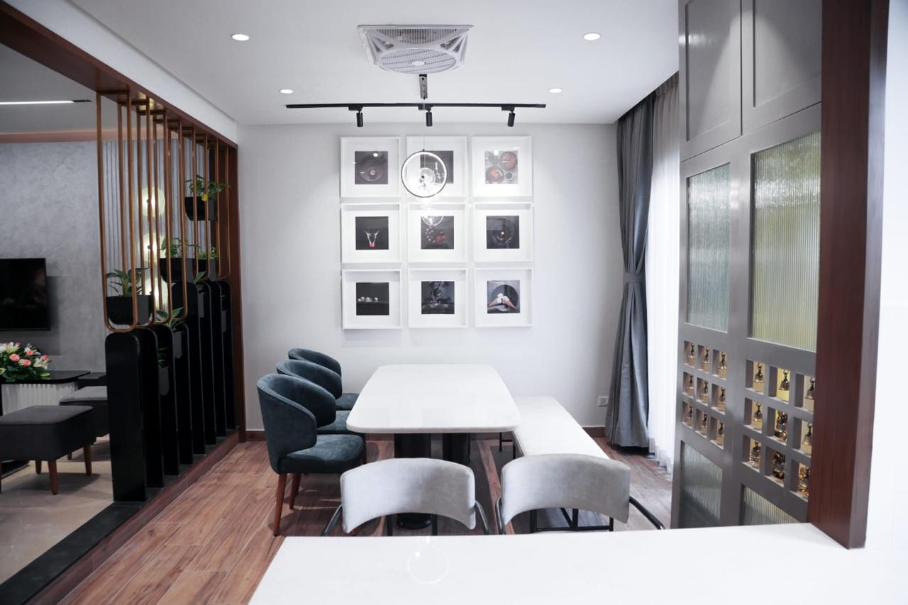 Contemporary dining room with gallery wall and wooden partition